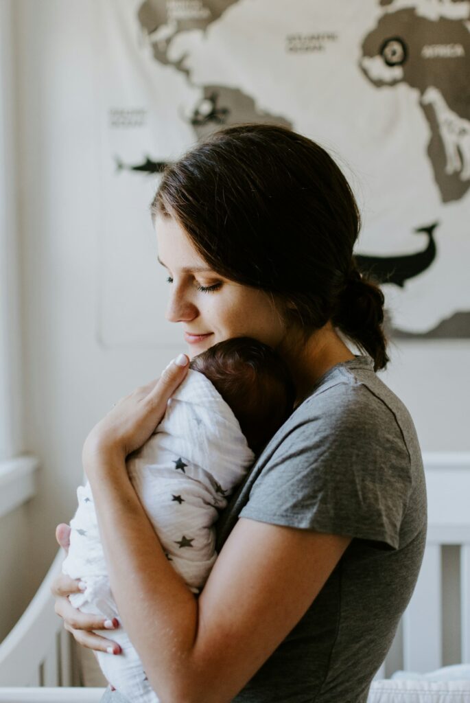 a mother holding her infant
